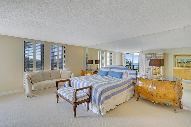 bedroom featuring light carpet and a textured ceiling