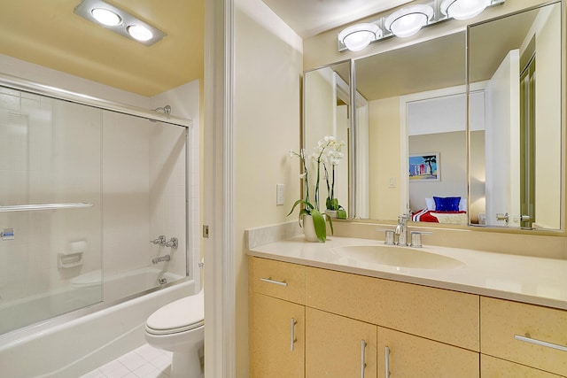 full bathroom with vanity, tile patterned flooring, combined bath / shower with glass door, and toilet