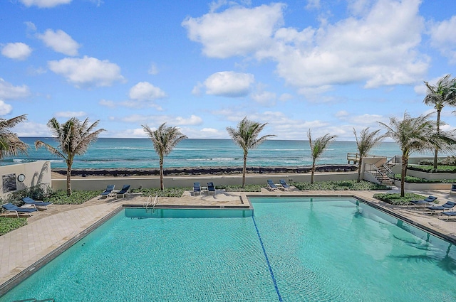 view of pool with a water view