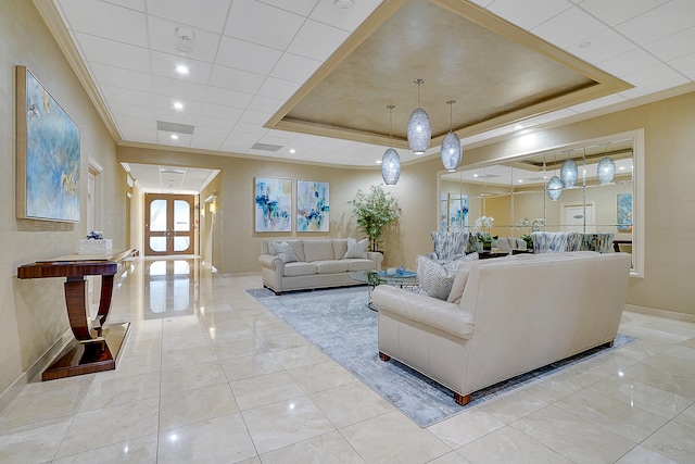 tiled living room featuring a tray ceiling and crown molding