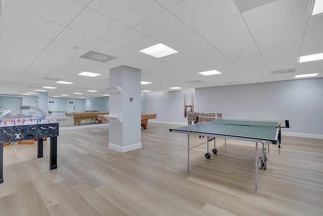 game room with pool table, a drop ceiling, and light hardwood / wood-style floors