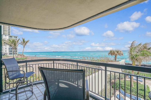 balcony with a view of the beach and a water view