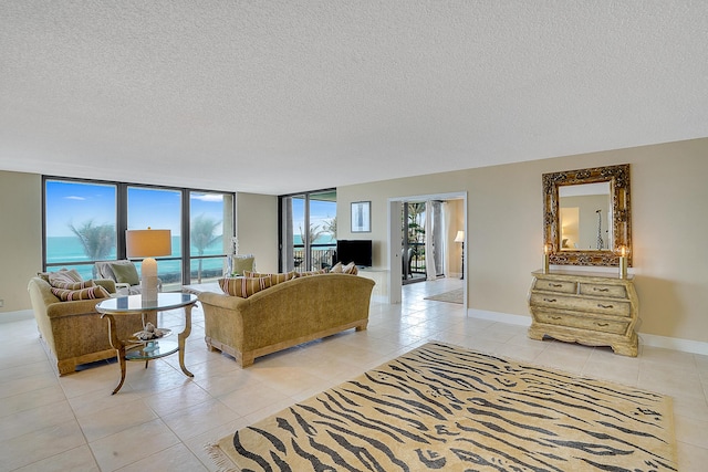 tiled living room featuring expansive windows and a textured ceiling