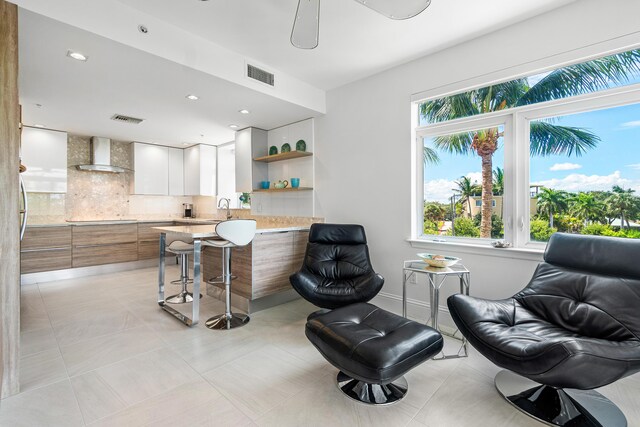 kitchen with a wealth of natural light, sink, tasteful backsplash, and stainless steel dishwasher