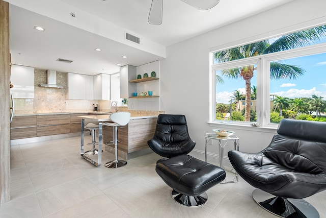 living area featuring light tile patterned flooring and sink