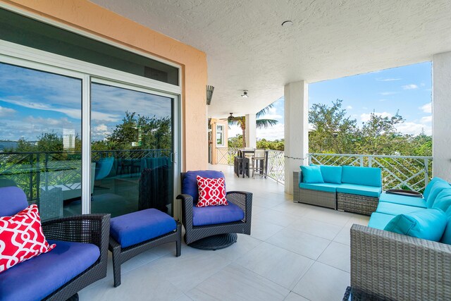 balcony with outdoor lounge area and a water view