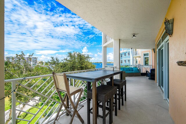 view of patio with a balcony and outdoor lounge area