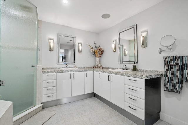 bathroom with walk in shower and vanity