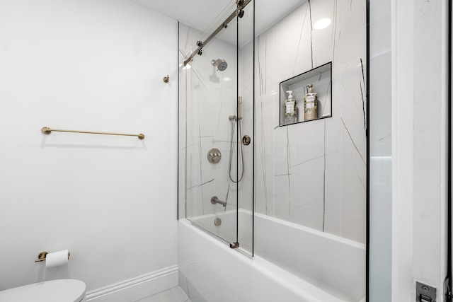 bathroom with toilet and combined bath / shower with glass door