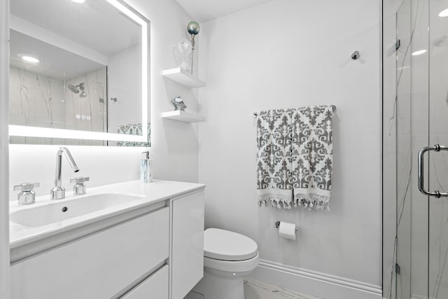 bathroom featuring vanity, toilet, and an enclosed shower