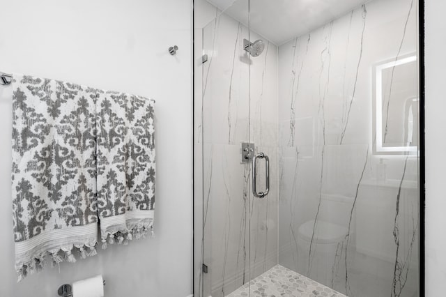 bathroom featuring a shower with door