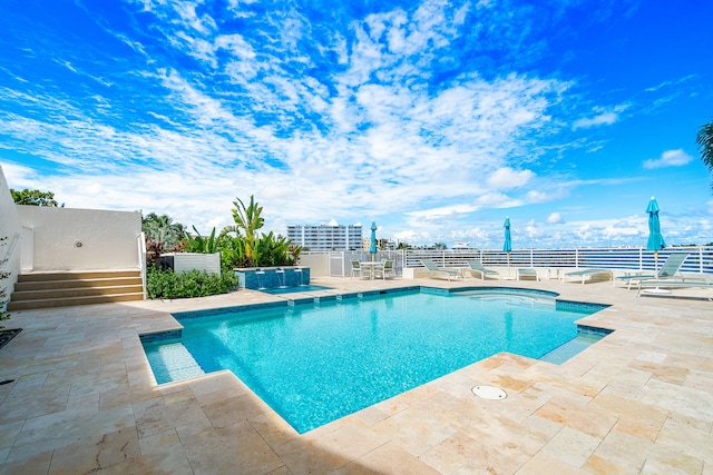 view of swimming pool featuring a patio area