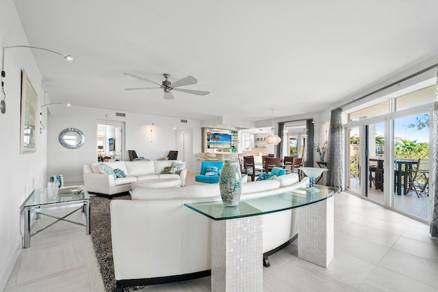 tiled living room with ceiling fan