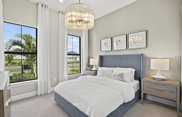 carpeted bedroom with an inviting chandelier