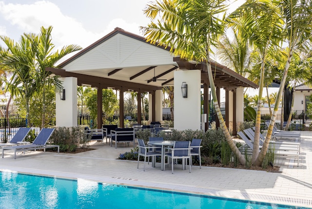 view of pool with ceiling fan, a patio area, and a gazebo