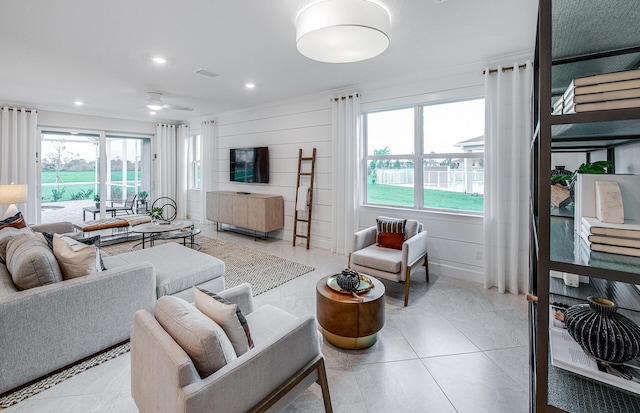 living room featuring ceiling fan and light tile patterned floors