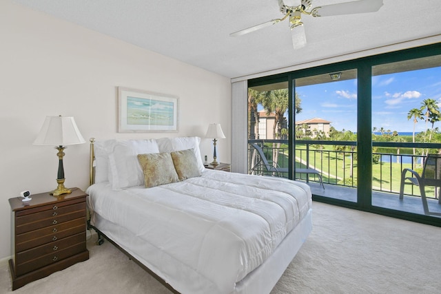 bedroom with ceiling fan, floor to ceiling windows, access to exterior, and carpet flooring