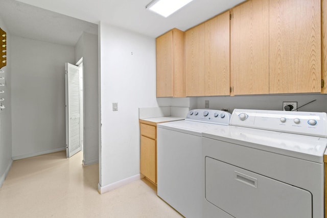 laundry area with cabinets and separate washer and dryer