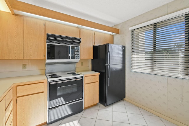 kitchen with light brown cabinetry and black appliances