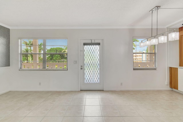 interior space with a textured ceiling, plenty of natural light, ornamental molding, and a notable chandelier