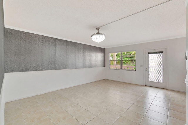 tiled spare room with crown molding