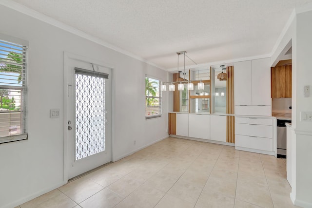 interior space featuring light tile patterned floors, a textured ceiling, and crown molding