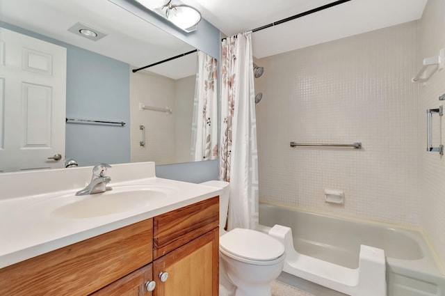 full bathroom with vanity, shower / tub combo, and toilet