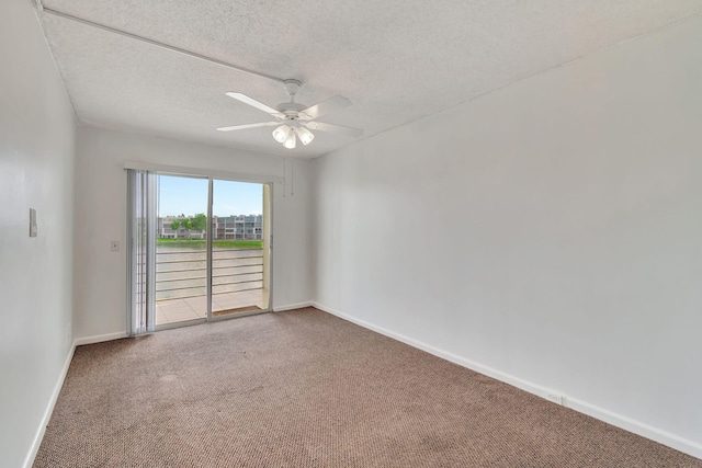 carpeted empty room featuring ceiling fan and a textured ceiling