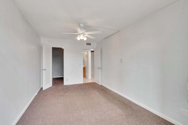 empty room featuring carpet flooring and ceiling fan