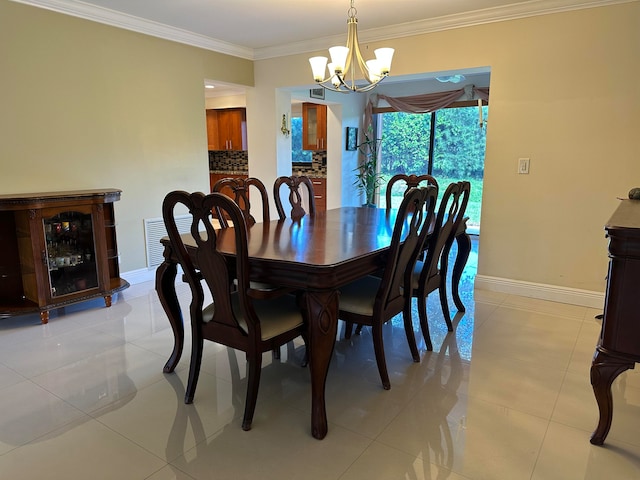 tiled dining space featuring an inviting chandelier and ornamental molding