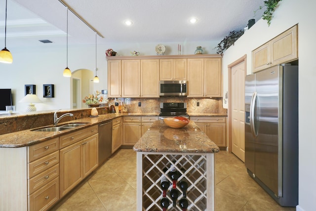 8100 Alister Pl, Port Saint Lucie, FL 34986 - kitchen featuring stainless steel appliances, a sink, tasteful backsplash, a peninsula, and dark stone countertops