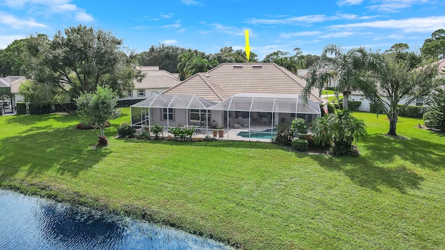 rear view of property featuring a water view, glass enclosure, and a yard