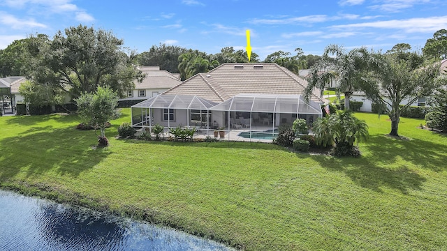 8100 Alister Pl, Port Saint Lucie, FL 34986 - rear view of house with an outdoor pool, a tile roof, a yard, and a water view
