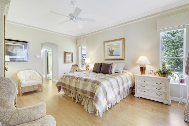 8100 Alister Pl, Port Saint Lucie, FL 34986 - bedroom featuring arched walkways, multiple windows, light wood-style flooring, and crown molding
