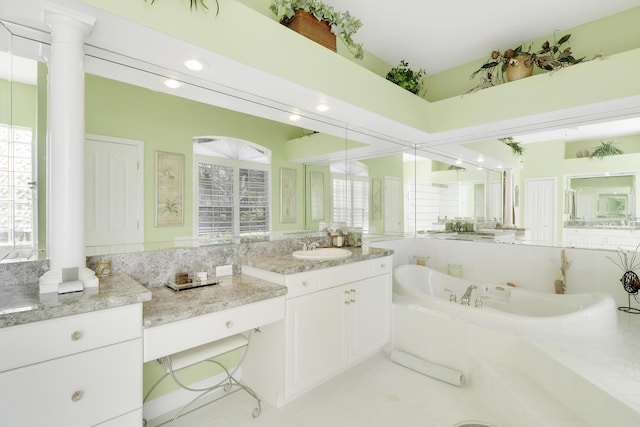 8100 Alister Pl, Port Saint Lucie, FL 34986 - bathroom featuring decorative columns, a bath, and vanity