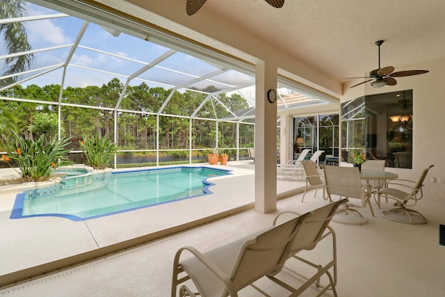 view of swimming pool featuring ceiling fan, a patio, and a lanai