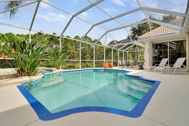 view of swimming pool featuring glass enclosure and a patio area