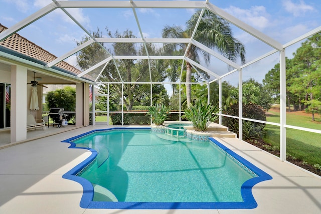 view of swimming pool featuring a patio, glass enclosure, and ceiling fan