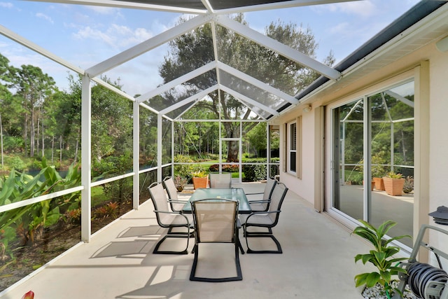 sunroom / solarium featuring lofted ceiling