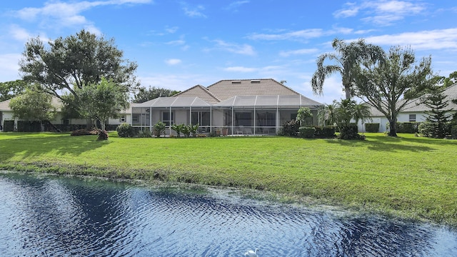 8100 Alister Pl, Port Saint Lucie, FL 34986 - rear view of house featuring a water view, a lawn, a tile roof, and a lanai