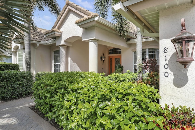 8100 Alister Pl, Port Saint Lucie, FL 34986 - doorway to property featuring stucco siding and a tiled roof