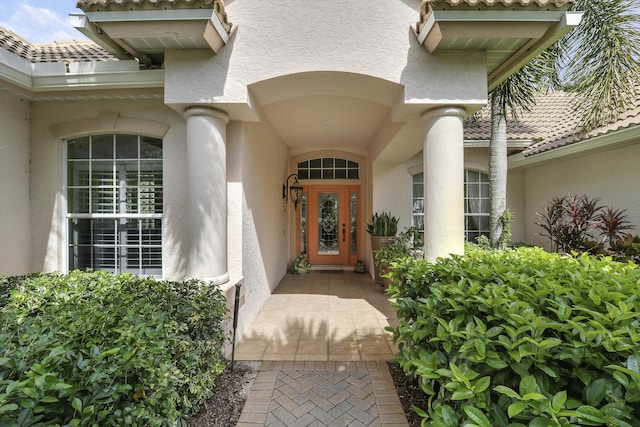 8100 Alister Pl, Port Saint Lucie, FL 34986 - view of exterior entry featuring stucco siding and a tile roof