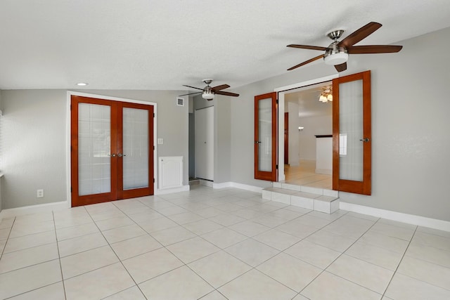 empty room featuring french doors, light tile patterned flooring, baseboards, a textured ceiling, and ceiling fan
