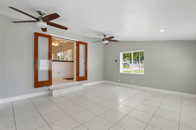 spare room featuring baseboards, a ceiling fan, a textured ceiling, recessed lighting, and light tile patterned flooring