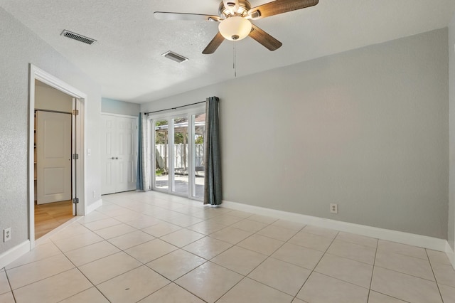 empty room featuring visible vents, baseboards, and ceiling fan
