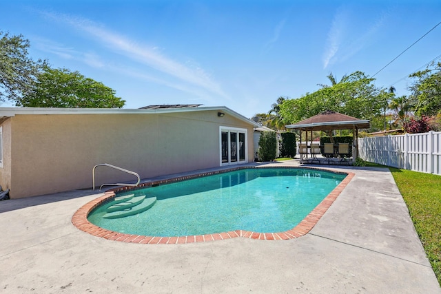 view of pool featuring a gazebo, a patio area, french doors, fence, and a fenced in pool