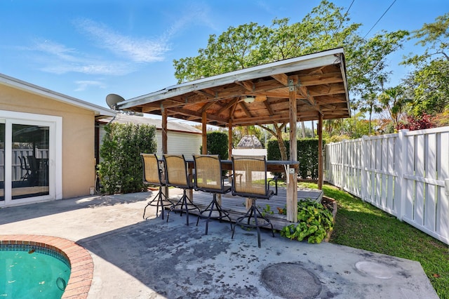 view of patio / terrace with a gazebo, a fenced backyard, and outdoor dining area