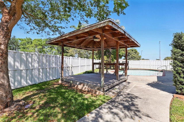 view of yard with a gazebo, a fenced in pool, a fenced backyard, and a deck
