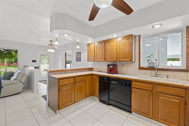 kitchen featuring ceiling fan, sink, kitchen peninsula, black dishwasher, and decorative backsplash