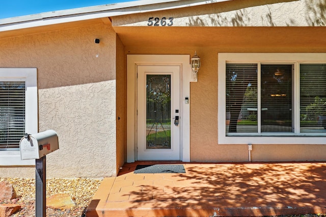 entrance to property with stucco siding